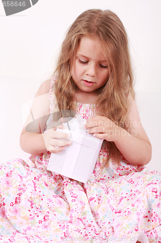 Image of Little girl opening present