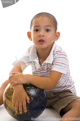 Image of cute boy with bowling ball