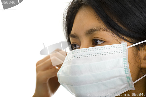 Image of woman putting on a face mask