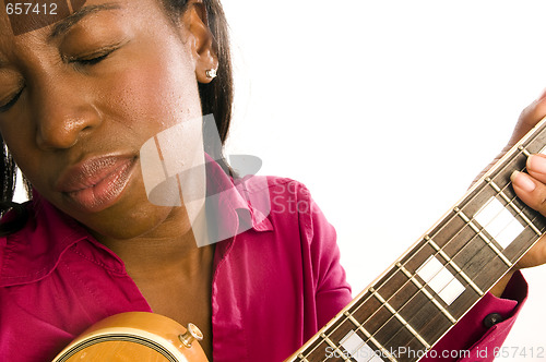 Image of young hispanic black woman playing electric guitar