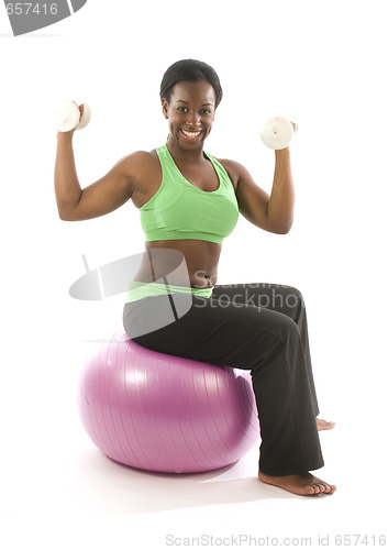 Image of young pretty hispanic african american woman exercising with fit