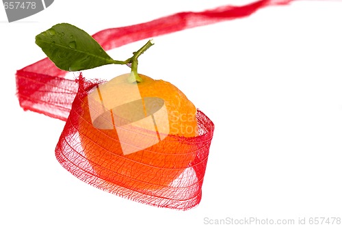 Image of christmas sweet in red bow. orange fruit