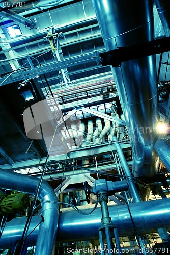 Image of Pipes, tubes, machinery and steam turbine at a power plant