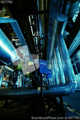 Image of Pipes, tubes, machinery and steam turbine at a power plant