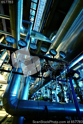 Image of Pipes, tubes, machinery and steam turbine at a power plant