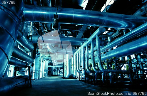 Image of Pipes, tubes, machinery and steam turbine at a power plant