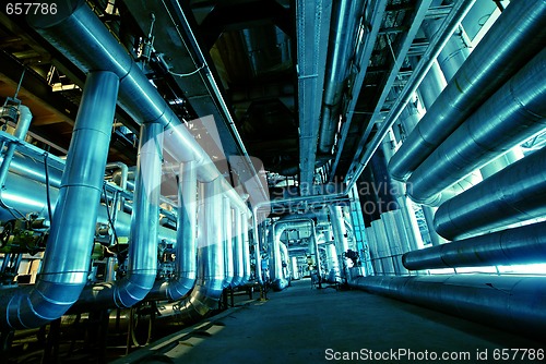 Image of Pipes, tubes, machinery and steam turbine at a power plant