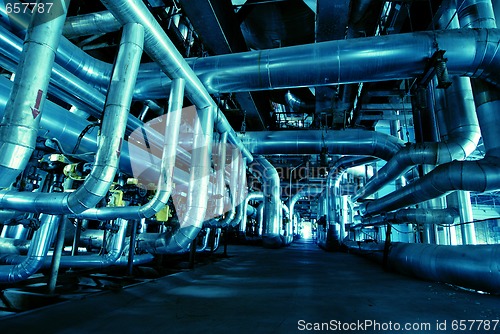 Image of Pipes, tubes, machinery and steam turbine at a power plant