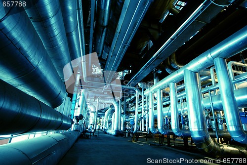 Image of Pipes, tubes, machinery and steam turbine at a power plant