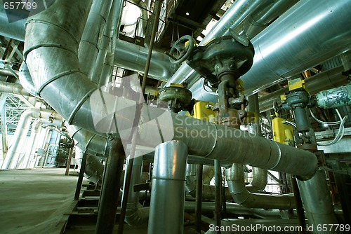 Image of Pipes, tubes, machinery and steam turbine at a power plant