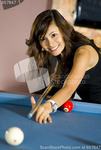 Image of woman playing pool