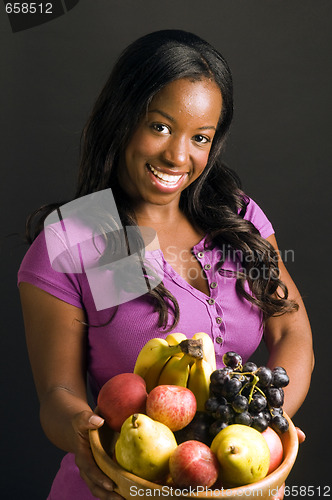 Image of pretty hispanic african american woman with healthy bowl of fres