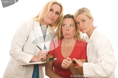 Image of two doctors nurses in medical scrubs clothes with patient