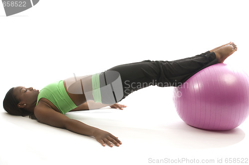 Image of young pretty hispanic african american woman exercising with fit