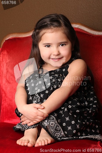 Image of Sweet Young Child Sitting in a Chair