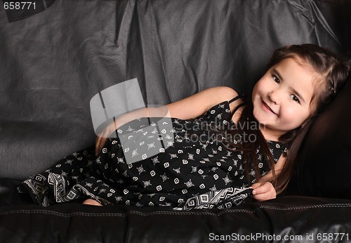 Image of Cute Young Child Lying on a Couch