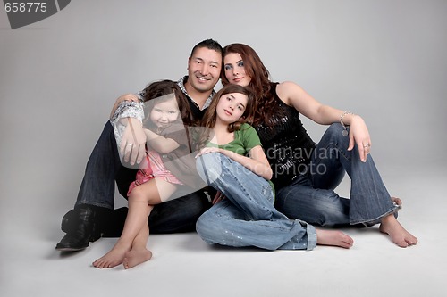 Image of Portriat of Siblings and Their Parents on Grey Background