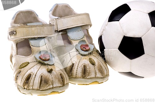 Image of Baby football shoes and ball on white background