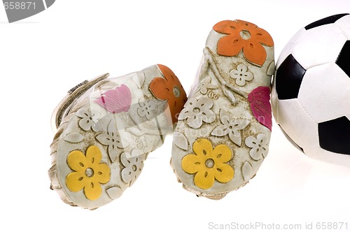 Image of Baby football shoes and ball on white background