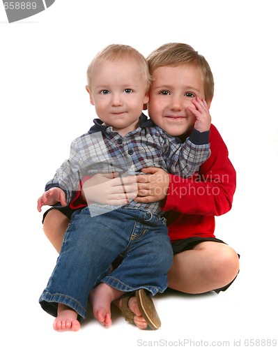 Image of Two Brothers Smiling and Sitting Together on White