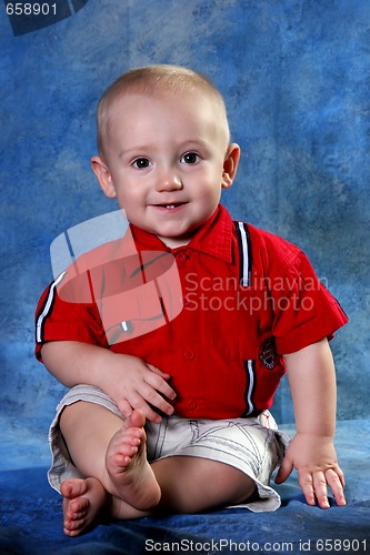 Image of Portrait of a Young Boy Against Blue Background