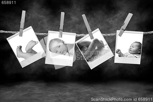 Image of Black and White Photographs Hanging on a Rope By Clothespins