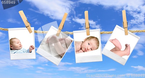 Image of Baby Photos Hanging Against a Blue Cloudy Sky