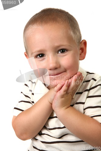 Image of Young Child With Hands Against His Face