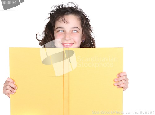 Image of Little School Girl Looking Over Her Book