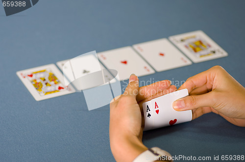 Image of 2 aces in hand and 3 on the table