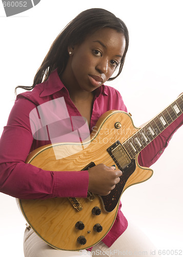 Image of young hispanic black woman playing electric guitar