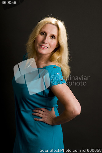 Image of glamorous woman posing in cocktail dress