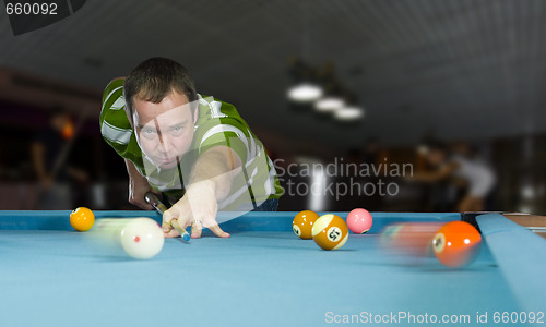 Image of caucasian man playing pool