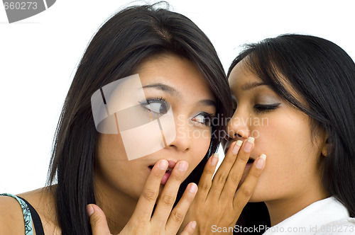 Image of two young asian friends gossip