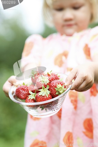 Image of Strawberries held by girl.