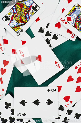 Image of poker cards on green silk