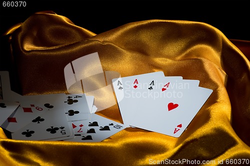 Image of 4 aces on golden silk