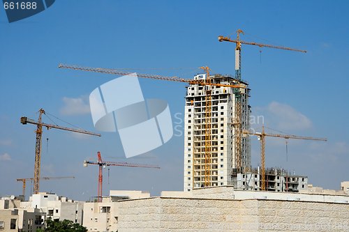Image of Six lifting cranes at construction site