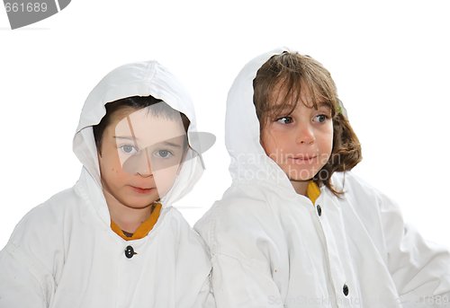 Image of Cute preschool boy and girl in white hooded cloaks isolated