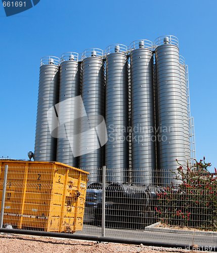 Image of Twelve high metal tower silos on chemical plant