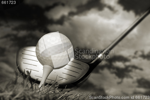 Image of Golf club and ball in grass