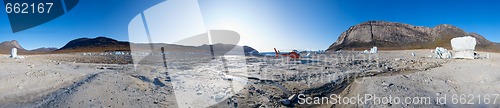 Image of Icebergs and red helicopter in the middle of a dried out lake