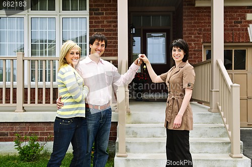 Image of Happy couple with real estate agent