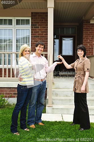 Image of Happy couple with real estate agent