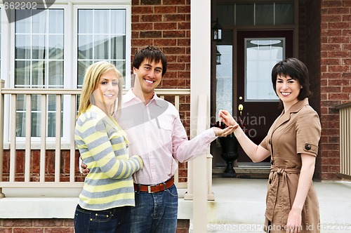 Image of Happy couple with real estate agent