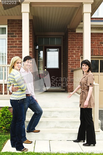 Image of Happy couple with real estate agent