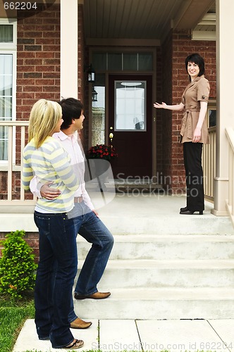 Image of Happy couple with real estate agent