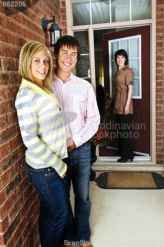 Image of Happy couple with real estate agent