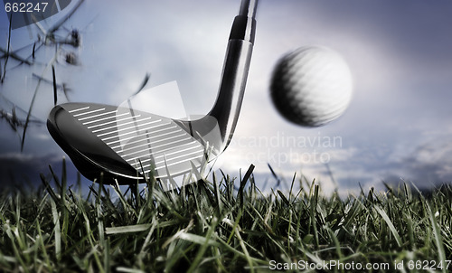 Image of Golf club and ball in grass