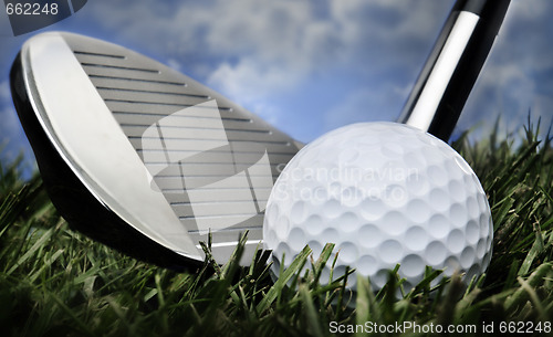 Image of Golf club and ball in grass